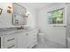 Bright bathroom featuring marble countertops, a window view, and modern lighting fixtures at 3316 Eden Way Cir, Carmel, IN 46033