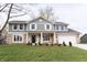 Charming two-story home with a manicured lawn, stone accents, and a welcoming front porch at 3316 Eden Way Cir, Carmel, IN 46033