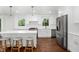 Modern kitchen with white cabinetry, an island with seating, and stainless steel appliances at 3316 Eden Way Cir, Carmel, IN 46033