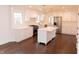 Bright, modern kitchen with white cabinets, stainless steel appliances, and a center island at 3316 Eden Way Cir, Carmel, IN 46033