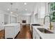 Bright, modern kitchen featuring an island with seating, white cabinetry, and stainless steel appliances at 3316 Eden Way Cir, Carmel, IN 46033