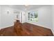 Bright, open room featuring hardwood floors, sconce lighting, and a view of the home's staircase at 3316 Eden Way Cir, Carmel, IN 46033
