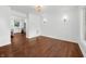 Bright room featuring hardwood floors, sconce lighting, and view to the kitchen at 3316 Eden Way Cir, Carmel, IN 46033