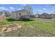 Backyard shot with wooden deck, grass, and a chain link fence and mature trees at 3346 S Lockburn St, Indianapolis, IN 46221