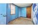 Bedroom featuring blue walls with carpet flooring and natural light from window at 3346 S Lockburn St, Indianapolis, IN 46221