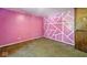 Bedroom featuring pink walls with white trim details, carpet flooring, and natural light at 3346 S Lockburn St, Indianapolis, IN 46221