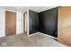 Bedroom featuring black accent wall, neutral carpet flooring and multiple entry doors at 3346 S Lockburn St, Indianapolis, IN 46221