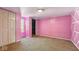 Bedroom featuring unique pink walls and white trim, carpet flooring, and natural light at 3346 S Lockburn St, Indianapolis, IN 46221