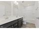 Modern bathroom featuring a double sink vanity, tub/shower combination, and vinyl flooring at 338 Mcnair Dr, Whiteland, IN 46184