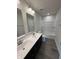 Modern bathroom with double sinks, white cabinets and a shower and tub combination at 338 Mcnair Dr, Whiteland, IN 46184