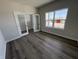 A serene bedroom with gray walls, stylish wood floors, bright window, and unique glass doors to an office at 338 Mcnair Dr, Whiteland, IN 46184