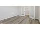 Bright bedroom with wood-look floors and glass doors that lead to another room at 338 Mcnair Dr, Whiteland, IN 46184