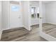 Inviting entryway features wood-look floors, white trim, and a door with glass panel at 338 Mcnair Dr, Whiteland, IN 46184