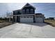 Beautiful two-story home with a blue exterior, white trim, a large driveway and an attached two-car garage at 338 Mcnair Dr, Whiteland, IN 46184