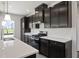 Stylish kitchen featuring dark cabinets, quartz countertops, and stainless steel appliances at 338 Mcnair Dr, Whiteland, IN 46184