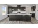 Modern kitchen with dark cabinets, quartz countertops, an island, and stainless steel appliances at 338 Mcnair Dr, Whiteland, IN 46184