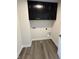 Utility room with gray cabinets, white walls and a hardwood floor at 338 Mcnair Dr, Whiteland, IN 46184