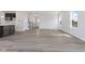 Bright living room with wood-look floors, large windows, and access to the kitchen at 338 Mcnair Dr, Whiteland, IN 46184