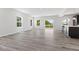 Spacious living room with wood-look floors, ample natural light, and patio doors at 338 Mcnair Dr, Whiteland, IN 46184