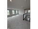 A spacious loft area with carpeting, multiple windows and a staircase at 338 Mcnair Dr, Whiteland, IN 46184