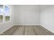 Well-lit room with hardwood floors and a large window at 338 Mcnair Dr, Whiteland, IN 46184