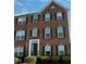 Charming brick townhouse featuring multiple windows and shutters at 3476 Golden Gate N Dr, Carmel, IN 46074