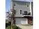 Exterior of a well-maintained townhouse with a balcony and a garage at 3476 Golden Gate N Dr, Carmel, IN 46074