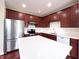 Modern kitchen features stainless steel appliances, white countertops, and rich wood cabinetry at 3476 Golden Gate N Dr, Carmel, IN 46074