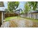 Large backyard wooden deck with swing set and privacy fence at 3544 Guilford Ave, Indianapolis, IN 46205
