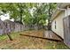 Wooden deck in fenced backyard with green foliage and trees at 3544 Guilford Ave, Indianapolis, IN 46205