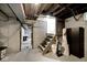 Unfinished basement with stairs, doorway, and stored items at 3544 Guilford Ave, Indianapolis, IN 46205