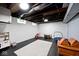 Bright basement featuring white-painted walls, exposed ceiling and play area with toys at 3544 Guilford Ave, Indianapolis, IN 46205