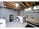 Basement laundry area with washer, dryer, utility sink, and shelving unit at 3544 Guilford Ave, Indianapolis, IN 46205