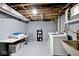 Basement laundry area with washer, dryer, utility sink, and folding table at 3544 Guilford Ave, Indianapolis, IN 46205