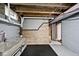 Unfinished basement featuring climbing wall, utility sink and exposed ceiling at 3544 Guilford Ave, Indianapolis, IN 46205