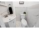 Elegant powder room with marble tile walls and decorative accent border at 3544 Guilford Ave, Indianapolis, IN 46205