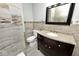 Bathroom features a dark wood vanity with a stone countertop, accent tiling, and toilet at 3544 Guilford Ave, Indianapolis, IN 46205