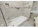 Bathroom featuring tiled shower/tub combo, accent tiling, and built in storage at 3544 Guilford Ave, Indianapolis, IN 46205
