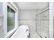 Bright bathroom featuring a free-standing tub, glass-enclosed shower, and stylish white marble tiling at 3544 Guilford Ave, Indianapolis, IN 46205