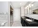 Bathroom featuring a double vanity, modern lighting, and stylish white marble tiling at 3544 Guilford Ave, Indianapolis, IN 46205