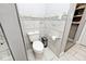 Modern bathroom featuring white marble tiling, toilet, and storage at 3544 Guilford Ave, Indianapolis, IN 46205