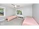 Bright bedroom with natural light, plush carpeting, and two twin beds for a comfortable space at 3544 Guilford Ave, Indianapolis, IN 46205
