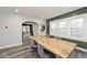 Bright dining room with hardwood floors, accent wall, and large windows at 3544 Guilford Ave, Indianapolis, IN 46205