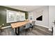 Airy dining room featuring hardwood floors, large windows, and a stylish table at 3544 Guilford Ave, Indianapolis, IN 46205