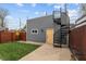 Charming backyard with a yellow door and black spiral staircase leading to the rooftop deck at 357 Parkway Ave, Indianapolis, IN 46225