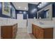 Cozy bathroom with wood vanity, decorative mirror, and modern fixtures at 357 Parkway Ave, Indianapolis, IN 46225