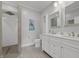 Modern bathroom with double vanity, a large mirror, and a walk-in shower with decorative tile at 357 Parkway Ave, Indianapolis, IN 46225