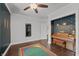 Bedroom featuring a piano, stylish wallpaper and hardwood flooring at 357 Parkway Ave, Indianapolis, IN 46225