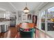 Dining room boasts wood floors, access to the outdoor patio and is open to the kitchen area at 357 Parkway Ave, Indianapolis, IN 46225