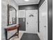 Welcoming foyer featuring stylish wallpaper, a decorative mirror, and sleek gray walls at 357 Parkway Ave, Indianapolis, IN 46225